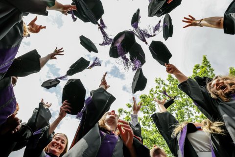 Photo of ONU law commencement where grads threw their hats in the center of photo