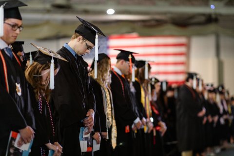 Photo from ONU Undergrad Commencement when the student all have their heads bowed