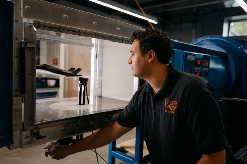 Photo of Aaron working on building an RC airplane