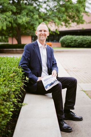 Robert Hartman seated on an outdoor bench