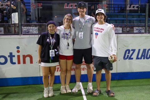 Martin posing with 3 others at a Lacrosse match