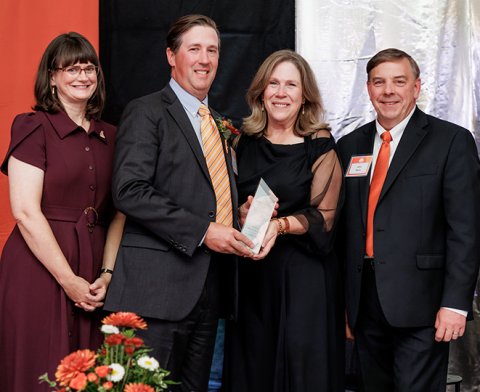 Josh Barrickman being presented with his Distinguished Alumni Award