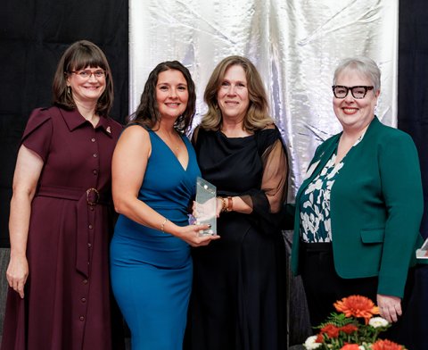 Angela Phares being presented with her Distinguished Alumni Award