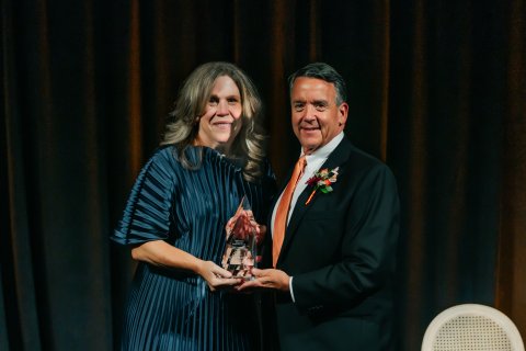 Photo of ONU president Baumann presenting corporate partner award to OFIC