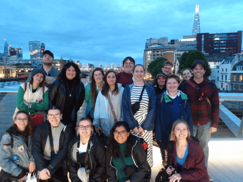 Photo of students posing in the night lights