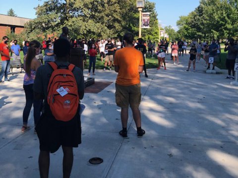 Students gathered around Martin Luther King Jr. statue