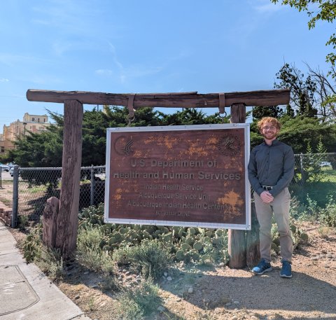 Photo of Lance by Albuquerque Indian Health Clinic signage