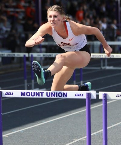 Photo of Olyvia jumping over a hurdle