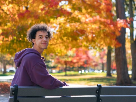 Photo of Nick on a park bench