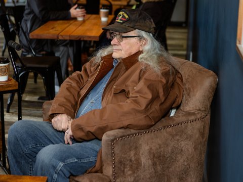 Photo of one of the 'coots' wearing a veterans ballcap