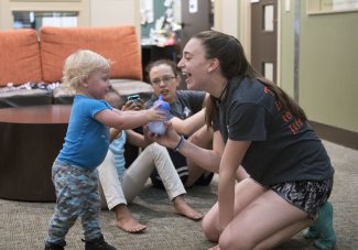 Student playing with child