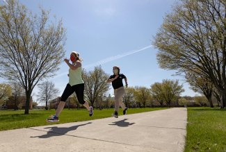Ohio Northern University staffer Joy Brown and student Samantha Hurlburt running on campus.