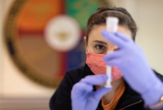 An Ohio Northern University pharmacy student prepares a COVID-19 vaccine syringe.