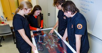 Photo of ONU nursing students using Anatomage Table