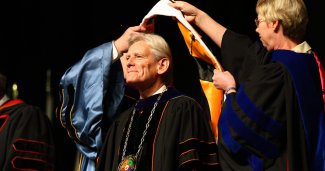 Photo of Dr. Baker getting hooded on graduation