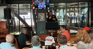 ONU Baseball Campaign launch with a speaker talking to a crowd