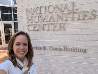 Ohio Northern University Assistant Professor of Communication Studies Megan Wood smiling in front of a National Humanities Center sign
