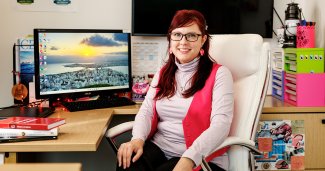 Dr. Lauren Logan seated in an office setting, smiling.
