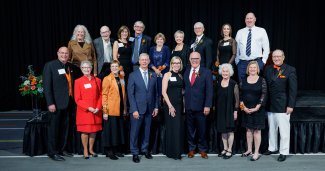 Attendees and award recipients gathered on stage at the annual H.S. Lehr Society dinner.
