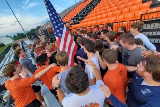 The ONU Men's Lacrosse Team with the American flag after finishing the team's annual 9/11 memorial run.
