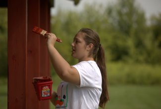 A volunteer painting during ACE Day in Ada, Ohio.