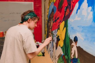 Aubrey Davis paints a mural of baseball player Ray Brown