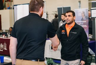 Two Ohio Northern University Career Fair participants shaking hands.