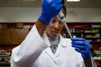 An Ohio Northern University College pharmacy student working in a lab.