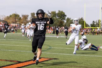 An ONU football player scores a touchdown during a 2021 game.