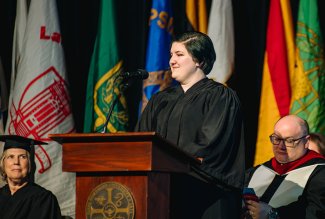 Photo of Chrysania Goldy reciting her poem for the Inaugration