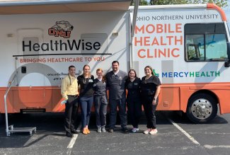 Ohio Northern University HealthWise Mobile Clinic volunteers posing in front of the RV.