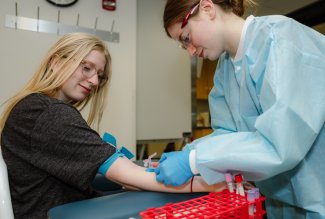 An Ohio Northern University medical laboratory sciences student prepares to take a blood sample