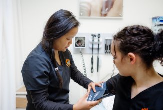 Ohio Northern University nursing students practicing how to measure blood pressure.