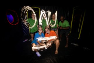Students use their phone flash feature to "write" ONU in the dark.