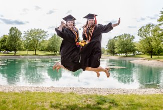 Two Ohio Northern University graduates at the Polar Bear pond after Commencement '23.