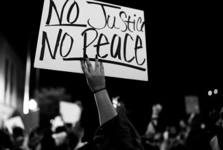 "No Justice No Peace" sign, black and white photo by Keith Helfrich via Unsplash.