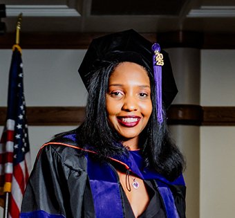 Photo of Camilla in her graduation garb